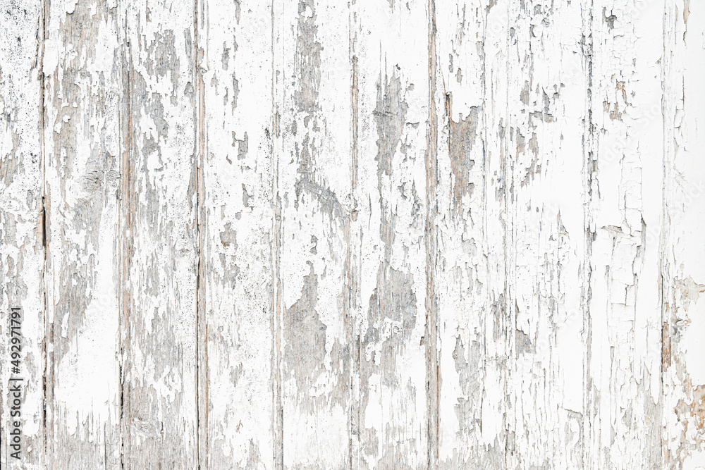 Mur en bois texturé dont la peinture blanche est écaillée