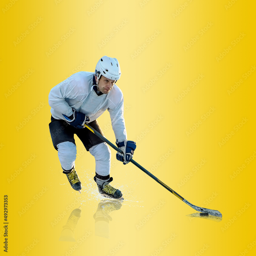 Fototapeta premium Professional ice hockey player hitting puck for winning goal in action on gradient multicolored neon background. Concept of sport competition.