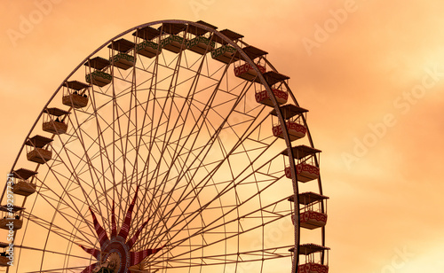 A Ferris wheel in Nice, France. An amusement ride consisting of a rotating upright wheel with multiple passenger-carrying components.