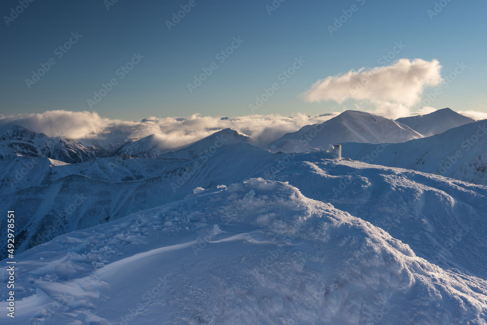 Beautiful winter views of the High Tatra Mountains with tourists, skiers and amazing states of nature	