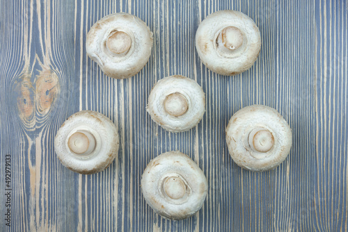 Champignon mushrooms on a wooden table.