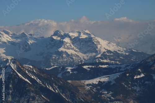 Snow covered peaks of the Swiss Alps on a cloudy morning. © u.perreten