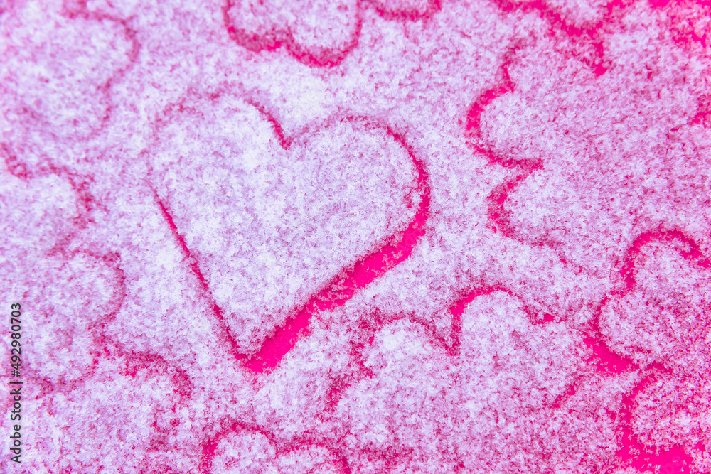 Love. Texture with heart figures on white snow.