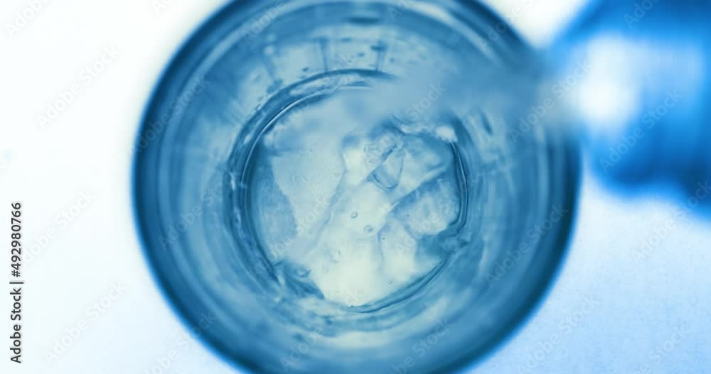 Pouring fresh pure sparkling water from bottle into a glass