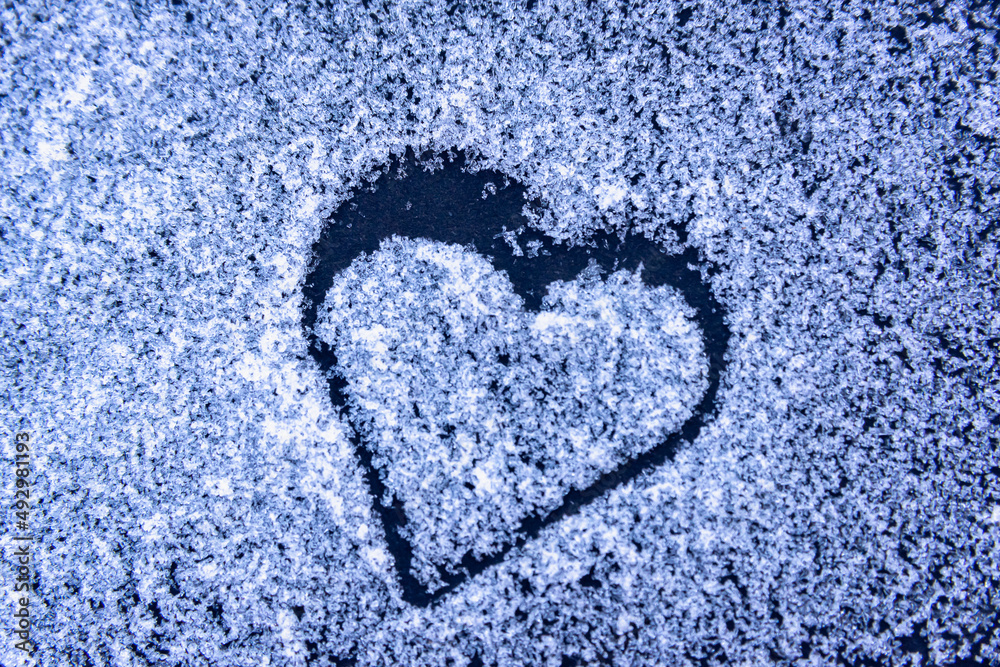 Love. Texture with hearts on white snow and black background.