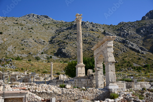 arch and column of ancient town sagalassos on mountain background, Turkey