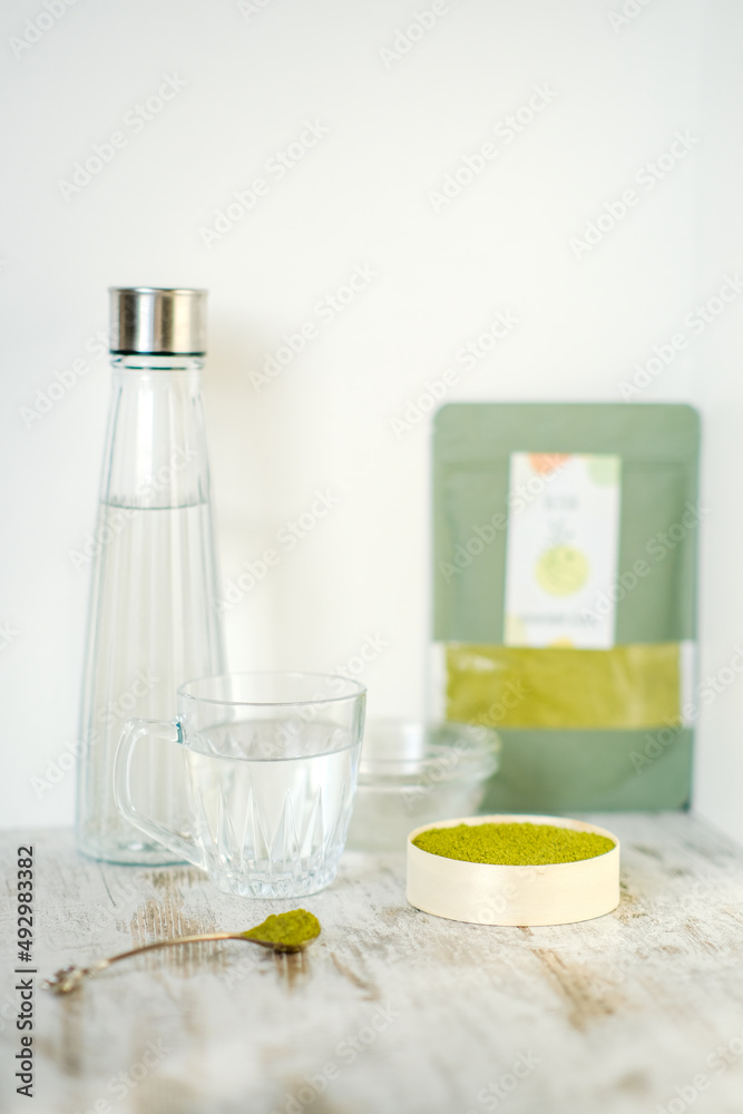 Green herbal detox powder in a plate on wooden table. Superfood. Organic eco health care. Vitamin nutrition and treatment. Immune system support. Alternative medicine. Dietary supplement, bowel clean. Green herbal detox powder in a plate on wooden table. Superfood. Organic eco health care. Vitamin nutrition and treatment. Immune system support. Alternative medicine. Dietary supplement, bowel clean.