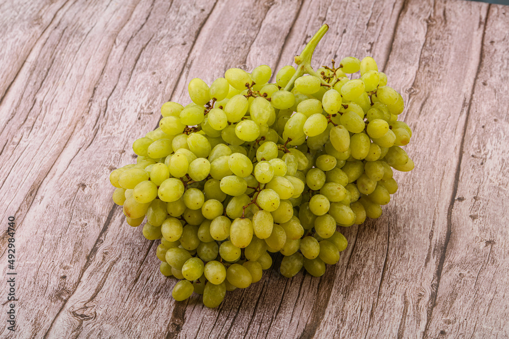 Green grape branch over background Green grape branch over background