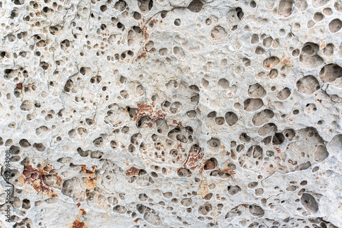 texture of porous stones on the beach, nature, natural phenomena, brown gray stones photo