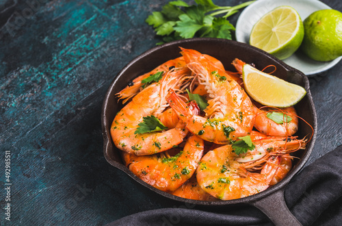 King shrimps stir-fried in pan tasty crustacean dark background copy space. 