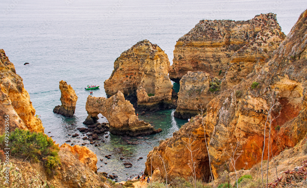 Panoramic view of Ponta da Piedade, Lagos in Algarve, Portugal   Cliffs, rocks and tourist boats at sea

