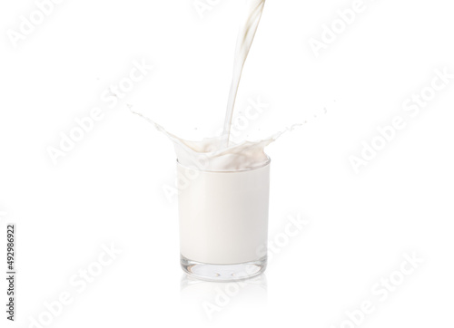 Stampa su tela Fresh milk pouring into glass with splash isolated on white background