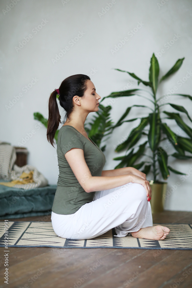 Young happy healthy fitness beautiful woman female doing and workout on yoga mat opposite at modern bedroom at home. Young happy healthy fitness beautiful woman female doing and workout on yoga mat opposite at modern bedroom at home.