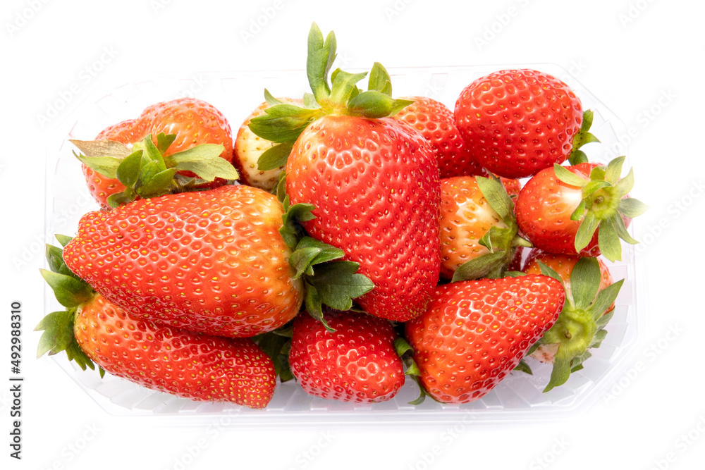 top view of whole red strawberries in a plastic tray top view of whole red strawberries in a plastic tray