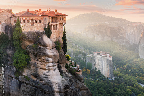 Obraz na płótnie Monastery of Varlaam and Saint Barbara Rousanos building on top of a sandstone rock with ray of light at sunrise. Must-visit iconic travel and pilgrimage destinations of the World w salonie