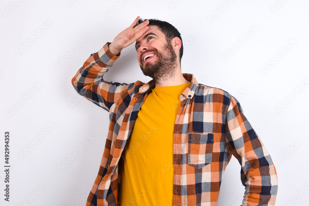 young caucasian man wearing plaid shirt over white background touching forehead, hears something surprising, glad receive good news, feels relieved. Almost got in trouble. young caucasian man wearing plaid shirt over white background touching forehead, hears something surprising, glad receive good news, feels relieved. Almost got in trouble.