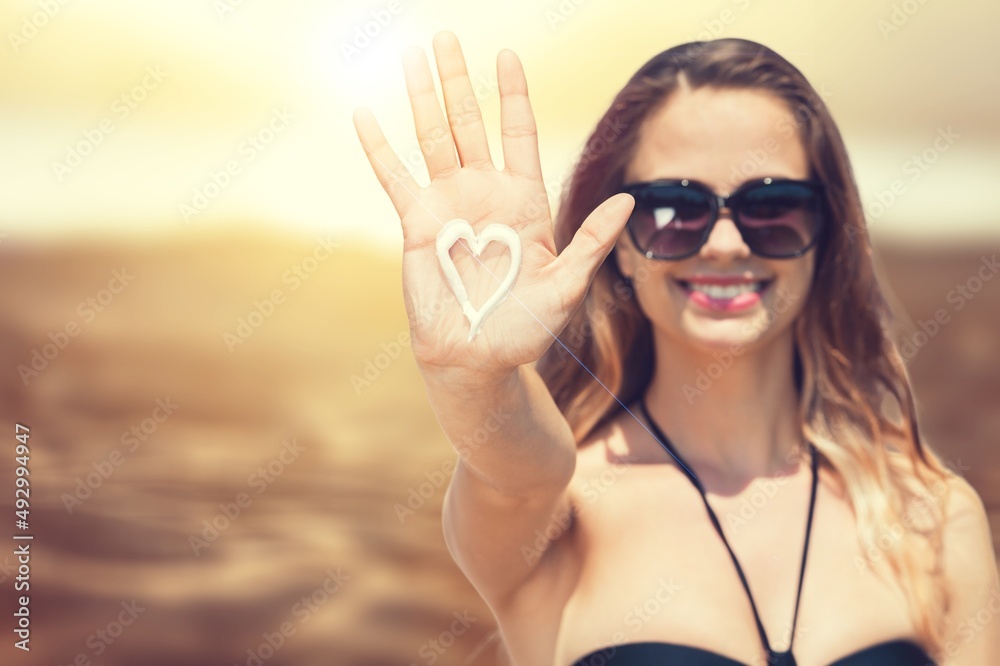 Beautiful woman with sun protection cream at beach Beautiful woman with sun protection cream at beach