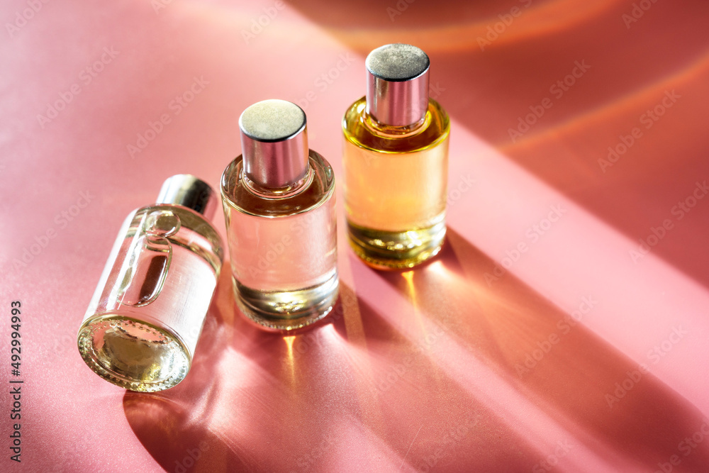 Glass bottle cosmetics with aroma oil for beauty or skin care on pink background, natural sun light and shades. Glass bottle cosmetics with aroma oil for beauty or skin care on pink background, natural sun light and shades.