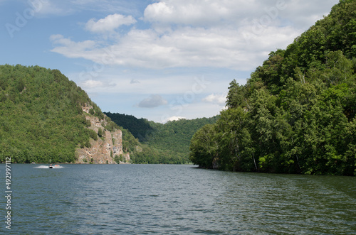 A panoramic view on the lake. The sky and mountains. Dense forest at the shore. Serenity. High quality photo. © NickiTerr