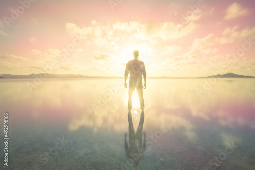 Silhouette of a man over the colorful and pink sunset of the calm waters of the Mar Menor in the Region of Murcia photo