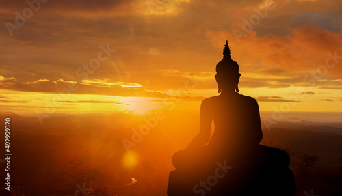 Stampa su tela buddha silhouette on golden sunset background beliefs of Buddhism