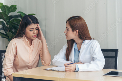 Woman doctor holding hands patient encourage cheer up consultation at hospital medicare treatment clinic. Doctor talking to patient support giving hope listening takecare for mental health therapy