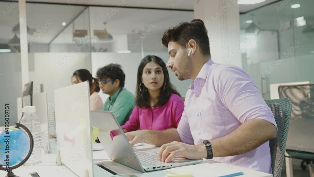 Young indian man using laptop planning for success in modern office, businessman typing and watching notebook with confident, executive with handsome and smart business concept. Young indian man using laptop planning for success in modern office, businessman typing and watching notebook with confident, executive with handsome and smart business concept.