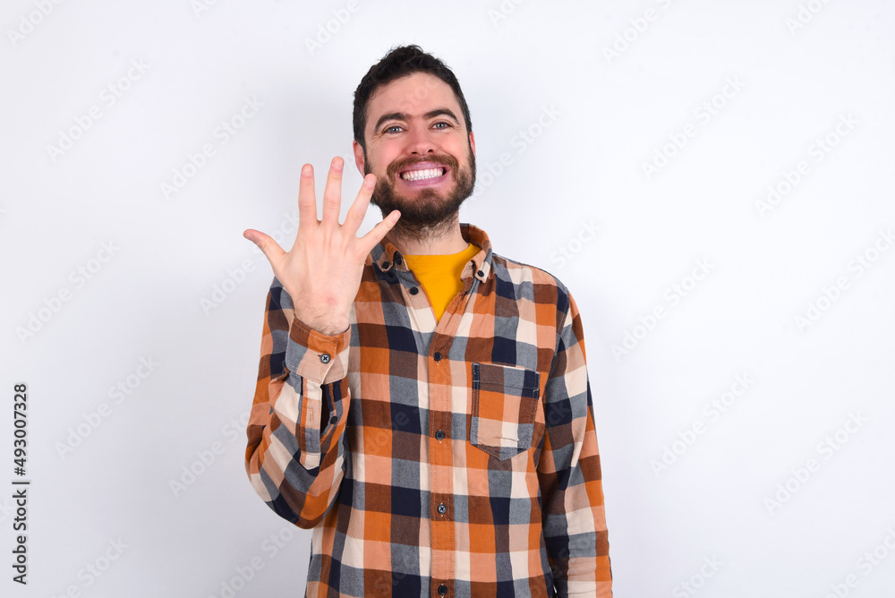 young caucasian man wearing plaid shirt over white background smiling and looking friendly, showing number five or fifth with hand forward, counting down young caucasian man wearing plaid shirt over white background smiling and looking friendly, showing number five or fifth with hand forward, counting down
