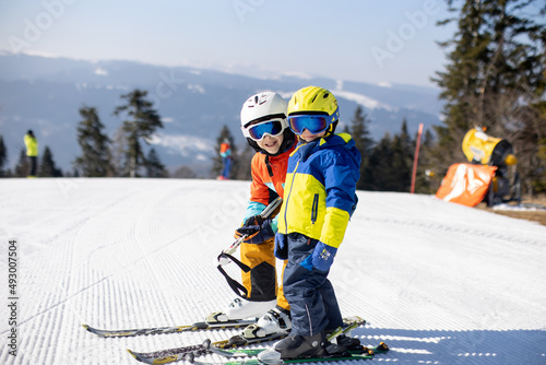 Happy family, skiing in Italy on a sunny day, kids and adults skiing together