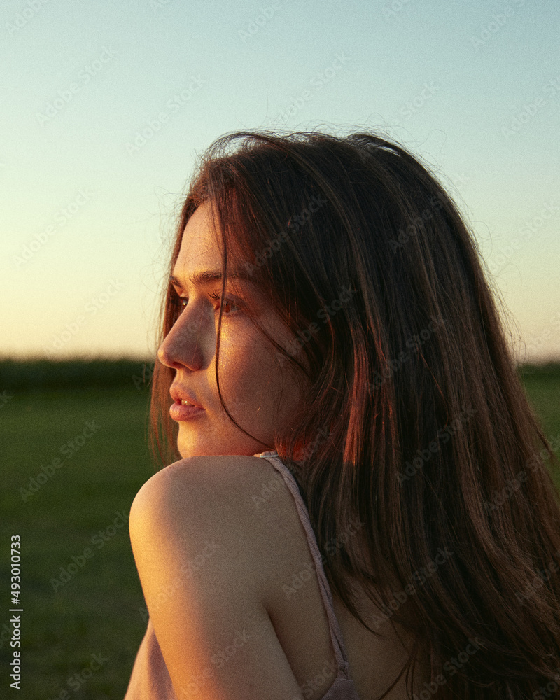 Brunette woman chilling in field on nature Brunette woman chilling in field on nature