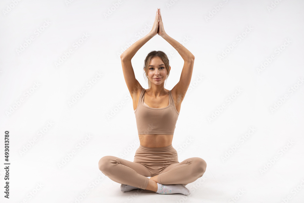 beautiful young woman meditating on white background 