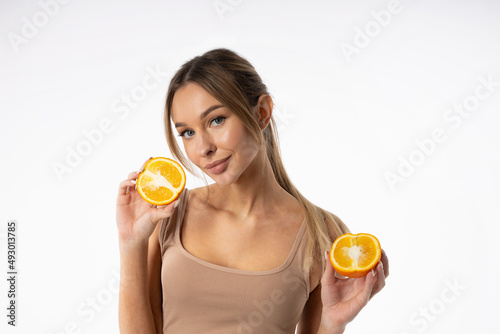 portrait of a cute attractive female with oranges 