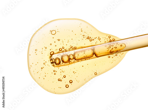 Liquid yellow vitamine c or retinol transparent gel or serum with dropper pipette on white isolated background photo