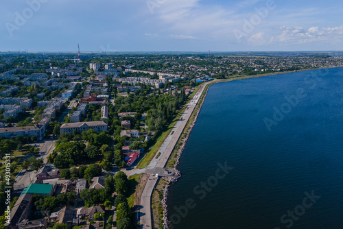 Kakhovskoye reservoir in the city of Nikopol. Ukraine. View from drone. Summer warm day. Place for a walk for adults and children near the water