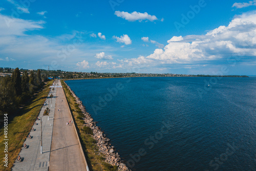 Kakhovskoye reservoir in the city of Nikopol. Ukraine. View from drone. Summer warm day. Place for a walk for adults and children near the water