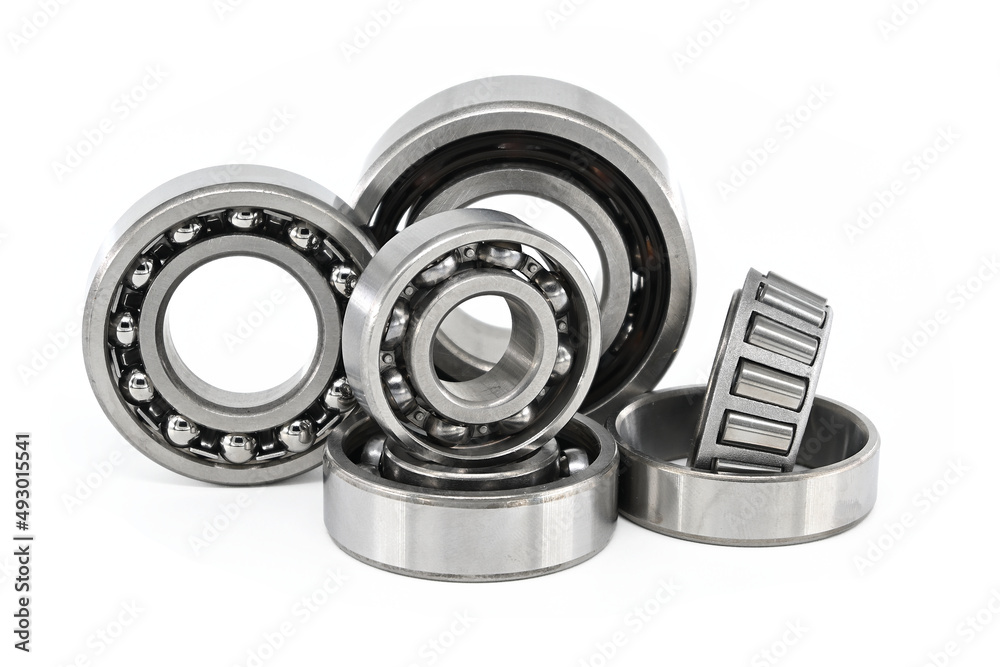 Group of various ball and roller bearings on white Group of various ball and roller bearings on white