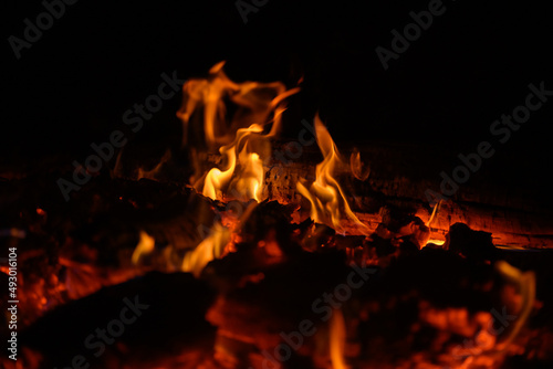 Bonfire winter dark night, view from top. Flame sores rise into lens. Roast oneself at fire on black backgroung isolated
