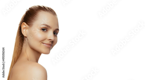 Portrait of young beautiful woman tenderly posing, looking at camera isolated over white studio background. Flyer