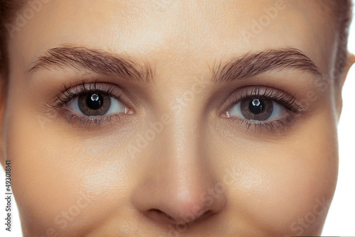 Cropped close-up image of beautiful female eyes, perfect smooth skin, natural make up
