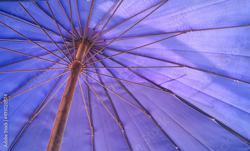 focus on structure of large umbrella that made of steel , its surface and texture made of purple canvas