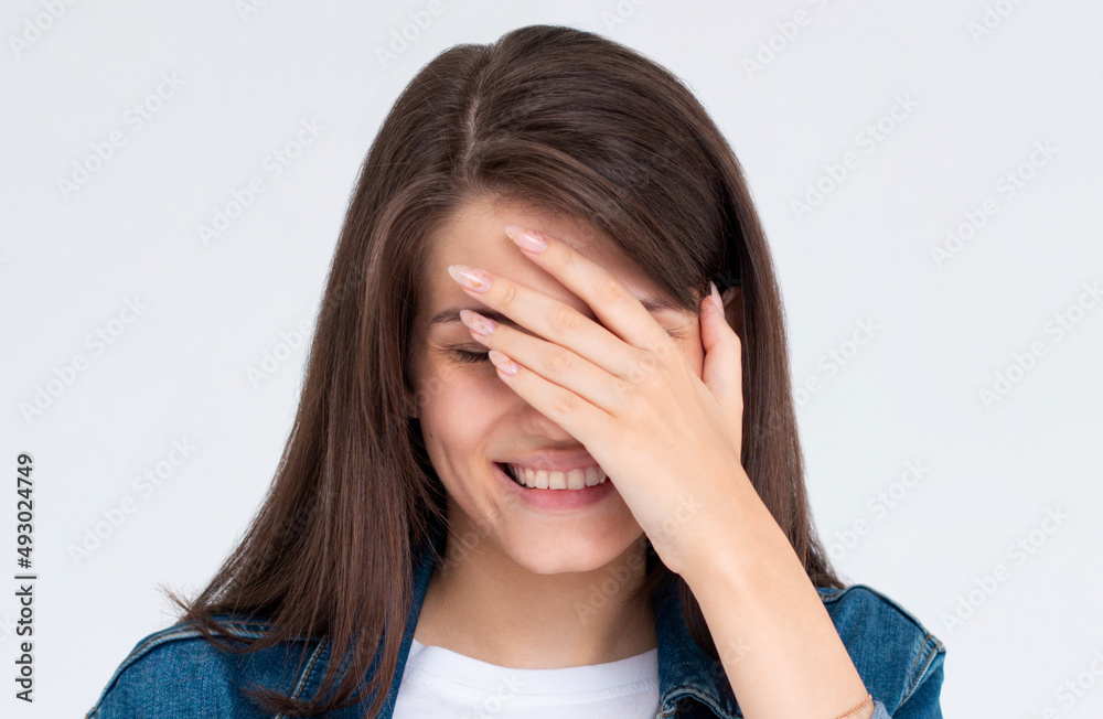 laughing woman embarrassed with her silliness covering with hand. facepalm failure and shame concept. laughing woman embarrassed with her silliness covering with hand. facepalm failure and shame concept.