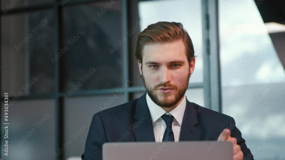 Smiling businessman looking at webcam camera making conference business call, conversation with client Smiling businessman looking at webcam camera making conference business call, conversation with client