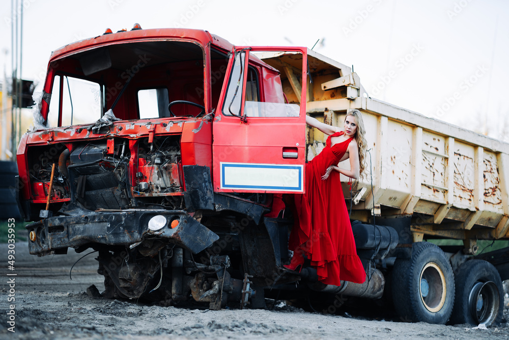 War in Ukraine girl in red near the blown up truck
