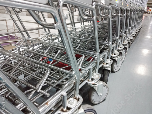 Row of empty supermarket shopping carts.Trolleys parked in department store.