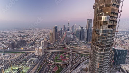 Scenic Dubai downtown skyline day to night timelapse. Rooftop view of Sheikh Zayed road photo