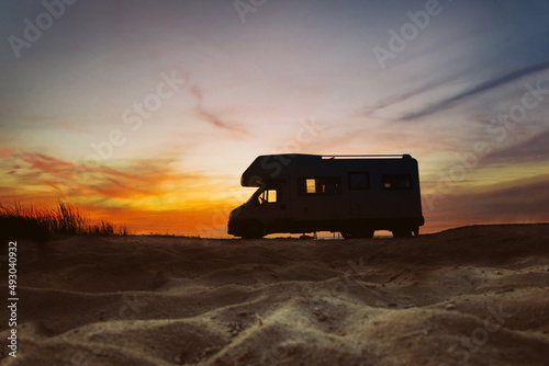 Leinwand Poster Sunset and caravan silhouette