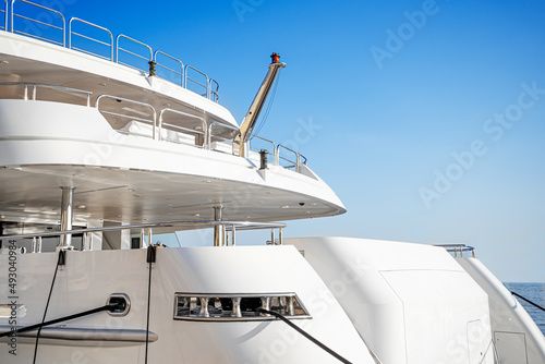 Part of a beautiful exquisite yacht against the sky.