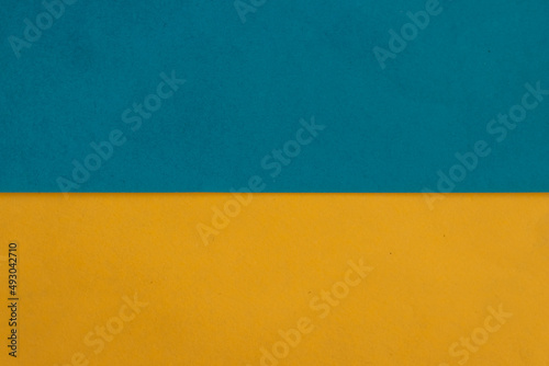 Ukraine flag from paper. Yellow and blue background