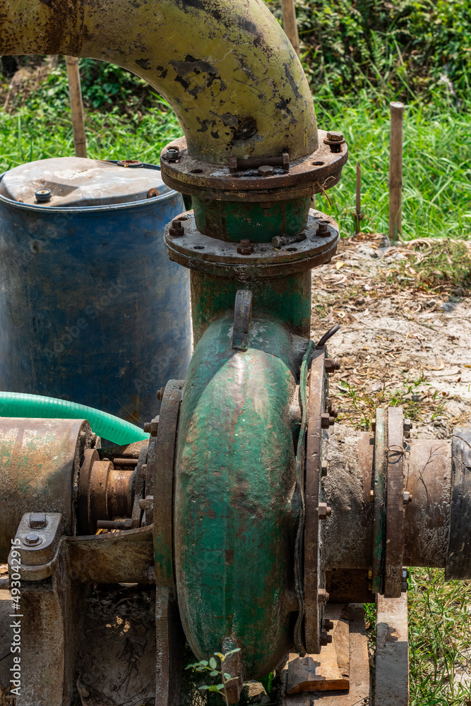 Old abandoned pump machine close up shot on a sunny day Old abandoned pump machine close up shot on a sunny day