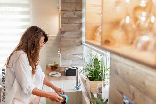 Woman doing the washing up after lunch